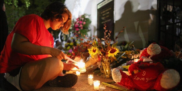 CHARLESTON, SC - JUNE 18: A woman lights candles for the nine victims of last night's shooting at the historic Emanuel Afric