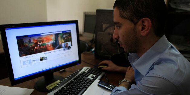 A Palestinian man looks at the Facebook page of Avichay Adraee, the spokesman of the Israeli Army to the Arabic media, after hackers replaced his cover photo with that of the Ezzedine al-Qassam Brigade during the '#Op_Israel' campaign launched by the activist group Anonymous, in Gaza City on April 7, 2013. The hackers reportedly hit several Israeli websites including that of the premier's office, the defence ministry, the education ministry and the Central Bureau of Statistics, among others, but all appeared to be running normally. AFP PHOTO/ SAID KHATIB (Photo credit should read SAID KHATIB/AFP/Getty Images)