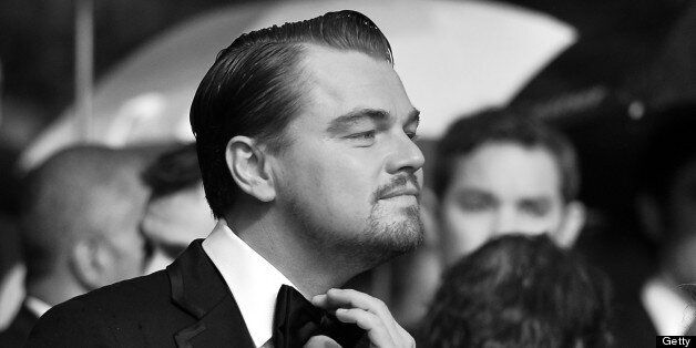 BLACK AND WHITE VERSION US actor Leonardo DiCaprio adjusts his bow tie on May 15, 2013 as he arrives for the screening of the film 'The Great Gatsby' ahead of the opening of the 66th edition of the Cannes Film Festival in Cannes. Cannes, one of the world's top film festivals, opens on May 15 and will climax on May 26 with awards selected by a jury headed this year by Hollywood legend Steven Spielberg. AFP PHOTO / ALBERTO PIZZOLI (Photo credit should read ALBERTO PIZZOLI/AFP/Getty Images)
