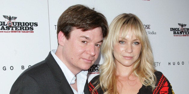 Actor Mike Myers and Kelly Tisdale attend The Cinema Society & Hugo Boss screening of 'Inglourious Basterds' at SVA Theater o