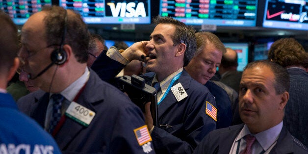 Traders work on the floor of the New York Stock Exchange (NYSE) in New York, U.S., on Thursday, Oct. 17, 2013. U.S. stocks fe