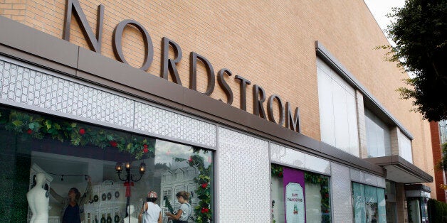 A woman carries a shopping bag while walking past a Nordstrom Inc. store in Santa Monica, California, U.S., on Tuesday, Nov. 12, 2013. Nordstrom Inc. is scheduled to release earnings figures on Nov. 14. Photographer: Patrick T. Fallon/Bloomberg via Getty Images