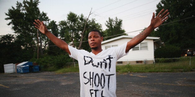 FERGUSON, MO - AUGUST 11: Protesters are forced by police from the business district into nearby neighborhoods on August 11, 2014 in Ferguson, Missouri. Police responded with tear gas and rubber bullets as residents and their supporters protested the shooting by police of an unarmed black teenager named Michael Brown who was killed Saturday in this suburban St. Louis community. Yesterday 32 arrests were made after protests turned into rioting and looting in Ferguson. (Photo by Scott Olson/Getty Images)