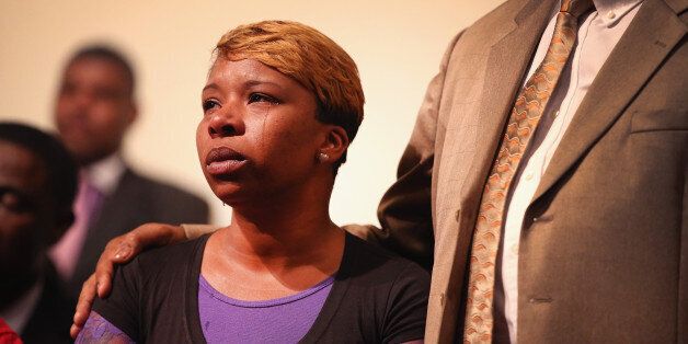 ST. LOUIS, MO - AUGUST 12: A tear rolls down the cheek of Lesley McSpadden, the mother of slain teenager Michael Brown, during a community meeting held at Greater St. Marks Family Church to discuss the killing of her son and the civil unrest resulting from his death on August 12, 2014 in St Louis, Missouri. Brown was shot and killed by a police officer on Saturday in the nearby suburb of Ferguson. Ferguson has experienced two days of violent protests since the killing but, tonight the town remained mostly peaceful. (Photo by Scott Olson/Getty Images)