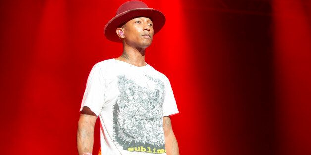 ABU DHABI, UNITED ARAB EMIRATES - NOVEMBER 22: Pharrell Williams performs on stage at du Arena, Yas Island on November 22, 2014 in Abu Dhabi, United Arab Emirates. (Photo by Helen Boast/Redferns via Getty Images)