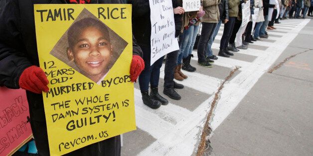 Demonstrators block Public Square Tuesday, Nov. 25, 2014, in Cleveland, during a protest over the weekend police shooting of Tamir Rice. The 12-year-old was fatally shot by a Cleveland police officer Saturday after he reportedly pulled a replica gun at the city park. (AP Photo/Tony Dejak)