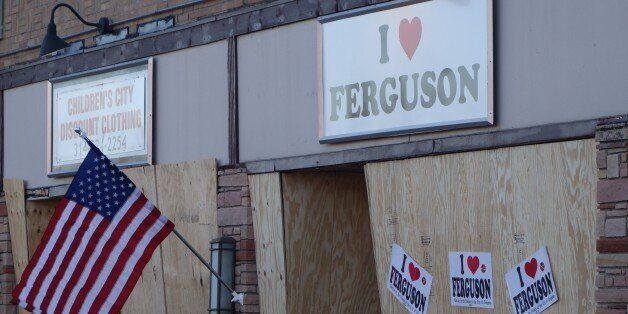 A local business is boarded up in anticipation of another night of unrest in Ferguson, Missouri on November 25, 2014. Protesters set buildings ablaze and looted stores in the US town of Ferguson on November 24 after a grand jury chose not to press charges against a white officer who shot dead a black teen. US President Barack Obama and the family of late 18-year-old Michael Brown appealed in vain for calm after a prosecutor said a grand jury had found the policeman acted in self-defense. AFP PHOTO/Michael B. Thomas (Photo credit should read Michael B. Thomas/AFP/Getty Images)