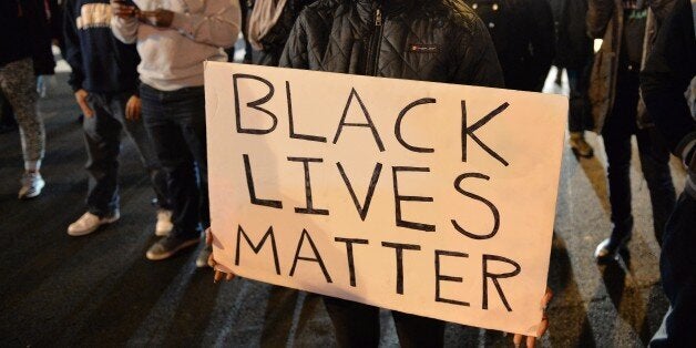 Protesters march on a street in Washington DC on December 05, 2014 during the third night of nationwide protests, after a grand jury decided not to charge a white police officer in the choking death of Eric Garner, a black man, days after a similar decision sparked renewed unrest in Missouri. Thousands of demonstrators marched in major cities across the United States on Friday in a fresh wave of protests against a spate of killings of unarmed black men by white police officers. Eric Garner died after being placed in a chokehold by New York police Officer Daniel Pantaleo while being arrested on suspicion of selling untaxed cigarettes in Staten Island. AFP PHOTO/MLADEN ANTONOV (Photo credit should read MLADEN ANTONOV/AFP/Getty Images)