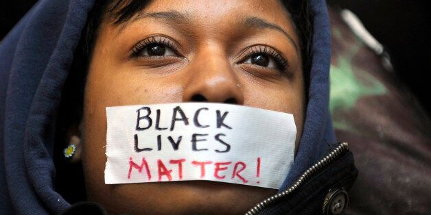 Penn State student Zaniya Joe wears a piece of tape over her mouth that says 'Black Lives Matter' during a Ferguson protest organized by a group of Penn State University students on Tuesday, Dec. 2, 2014, in University Park, Pa. (Nabil K. Mark/Centre Daily Times/TNS via Getty Images)