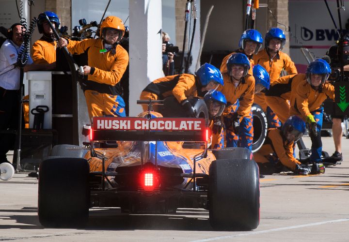 McLaren driver Carlos Sainz, of Spain, enters the pit as the team's crew members watch during the Formula One US Grand Prix auto race at the Circuit of the Americas in Austin, Texas, Sunday, Nov. 3, 2019.