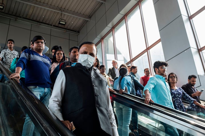 A commuter wearing a face mask as a preventive measure against the spread of the COVID-19 coronavirus at Kashmere Gate station of the Delhi Metro, in New Delhi on March 12, 2020.