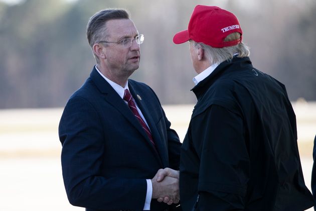 Doug Collins greets Trump last Friday as Air Force One arrived in Atlanta. Collins later learned that in late February he had come into contact with someone who tested positive for coronavirus.