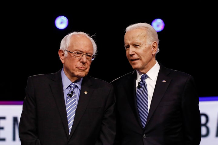 From left, Democratic presidential candidates, Sen. Bernie Sanders, I-Vt., former Vice President Joe Biden, talks before a Democratic presidential primary debate, Tuesday, Feb. 25, 2020, in Charleston, S.C. (AP Photo/Matt Rourke)