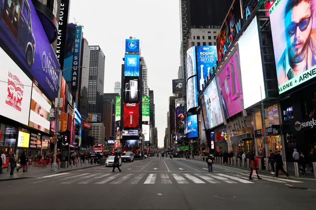 A nearly empty 7th Avenue in Times Square is seen at rush hour after it was announced that Broadway shows will cancel performances.