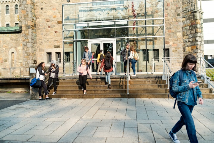 Students walk in and out of a university building in this stock photo. Colleges and universities in Canada's largest provinces are cancelling and suspending class amid the global pandemic of COVID-19.