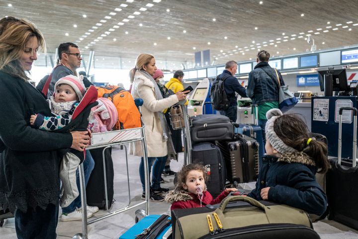 Passengers check in for flights bound for the United States at Paris' Charles de Gaulle Airport on March 12.