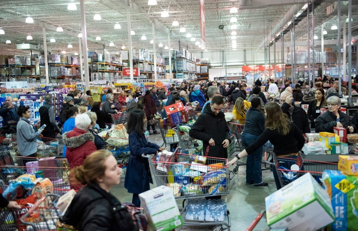 People line up at the cash registers at a Costco in Ottawa, amid growing concern about COVID-19, on Friday, March 13, 2020.
