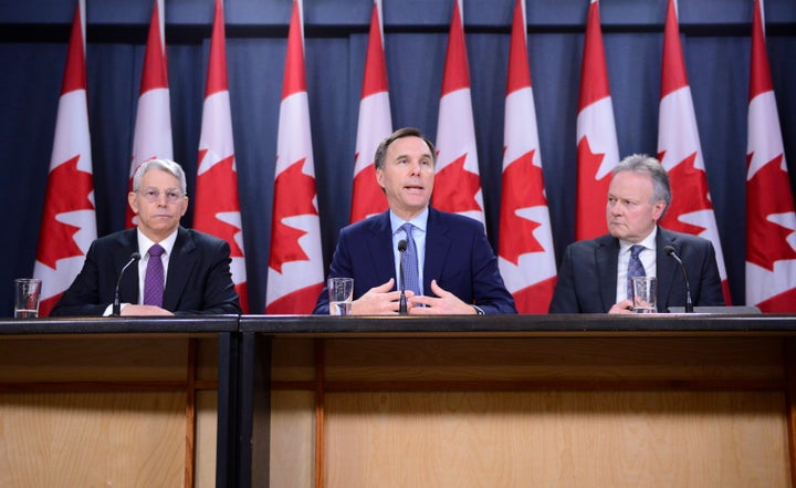 Superintendent of Financial Institutions Jeremy Rudin, left to right, Finance Minister Bill Morneau, and Bank of Canada Governor Stephen Poloz take part in a press conference at the National Press Theatre in Ottawa on March 13, 2020.