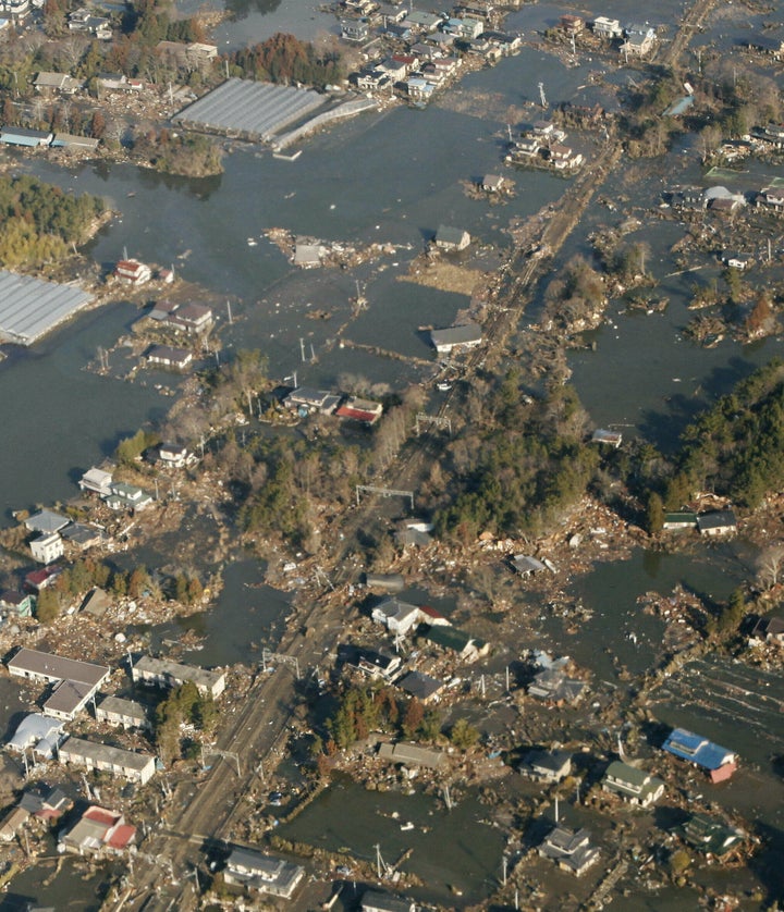 地震と津波により被害を受けた街。中央はJR常磐線の線路（宮城県上空）