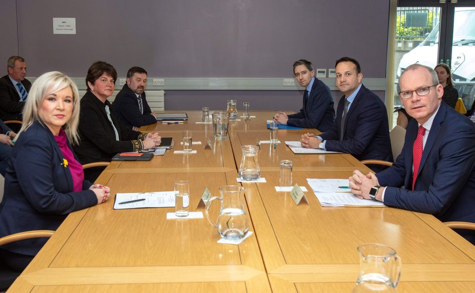 Ireland's Prime Minister, Leo Varadkar (2R), Northern Ireland's First Minister, Arlene Foster (2L), Northern Ireland Deputy First   Michelle O'Neill (L) and Tánaiste and Minister for Foreign Affairs and Trade Simon Coveney (R) gesture at the North South Ministerial Council offices in Armagh, Northern Ireland on March 14, 2020, before a meeting of the Irish Government and Northern Ireland Executive concerning the novel coronavirus Covid-19 outbreak. (Photo by Paul Faith / AFP) (Photo by PAUL FAITH/AFP via Getty Images)