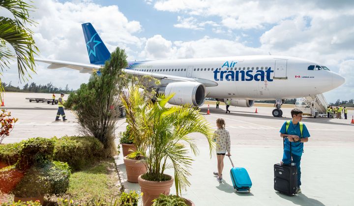 Passengers prepare to board an Air Transat airplane in Cuba on Feb. 19, 2016.