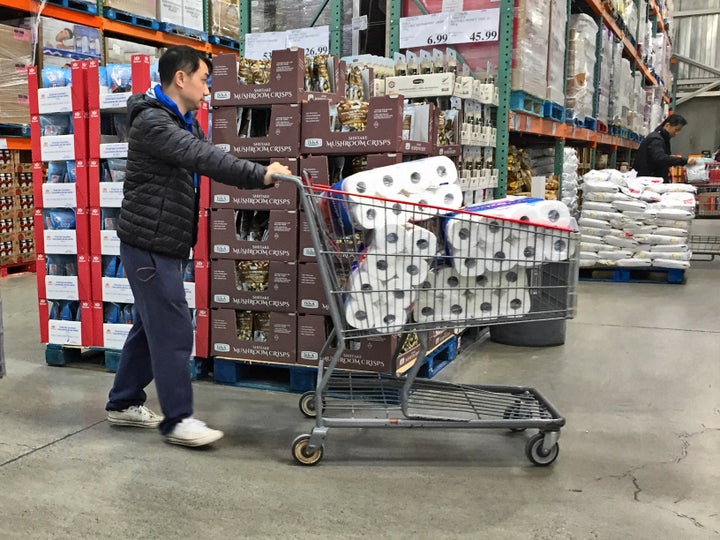 Man stocks up on toilet paper as Canadians purchase food and essential items in Markham, Ont. on March 7, 2020.