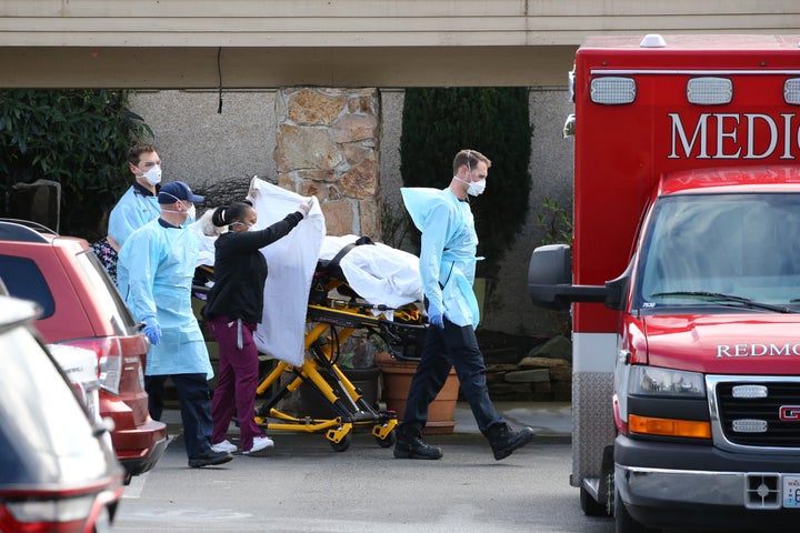 A patient is transferred to an ambulance at the Life Care Center in Kirkland, Washington. As of late last week, 26 residents there had died from COVID-19.