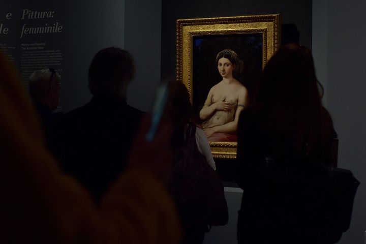 ROME, ITALY - MARCH 4: People look at the painting "Portrait of woman in the role of Venus (Fornarina)" of Raffaello Sanzio in the exhibition "Raffaello 1520 - 1483". on March 4, 2020 in Rome, Italy.