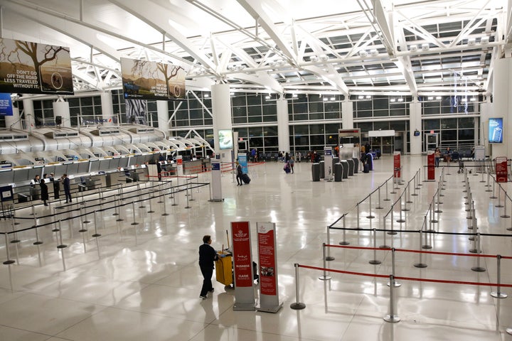 Few travelers are seen in a mostly empty flight check-in area at John F. Kennedy Airport's Terminal 1, Friday, March 13, 2020, in New York. Earlier this week, President Trump banned most foreign visitors coming to the United States from continental Europe to try to slow down the spread of the coronavirus. The ban, which lasts for 30 days, which starts at midnight Friday. Americans returning from Europe will be subject to enhanced health screening. (AP Photo/Kathy Willens)