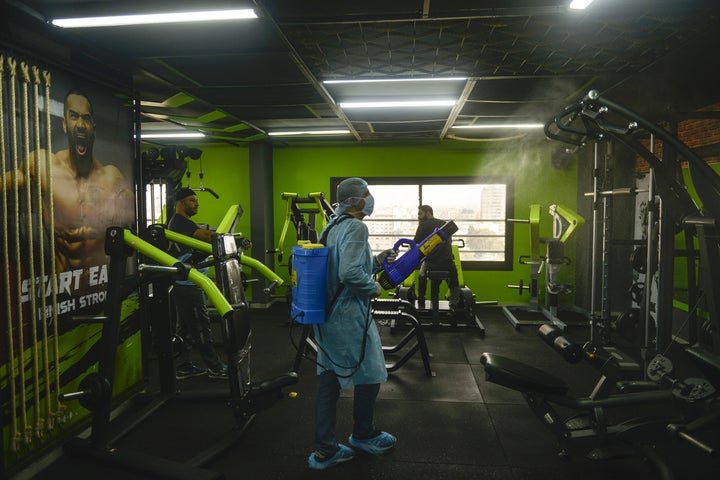 An official carries out disinfection work as a precaution against the coronavirus at a fitness centre in Gaza City.