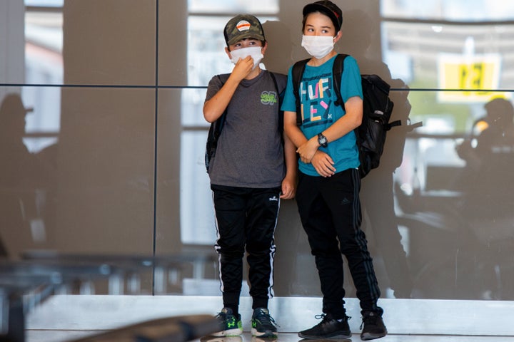 Kids play while wearing protective face masks in Phoenix, Arizona.