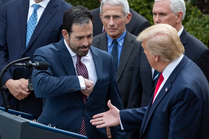 LHC Group's Bruce Greenstein elbow bumps with President Donald Trump during a news conference about the coronavirus on Friday.