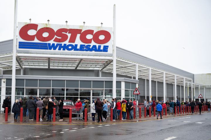 Customers queue to get into a Costco store which opens its doors at 11am in Cardiff.