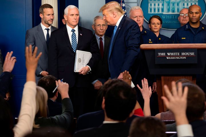 Reporters ask questions as President Donald Trump departs after speaking during a press briefing about the coronavirus on Sunday.