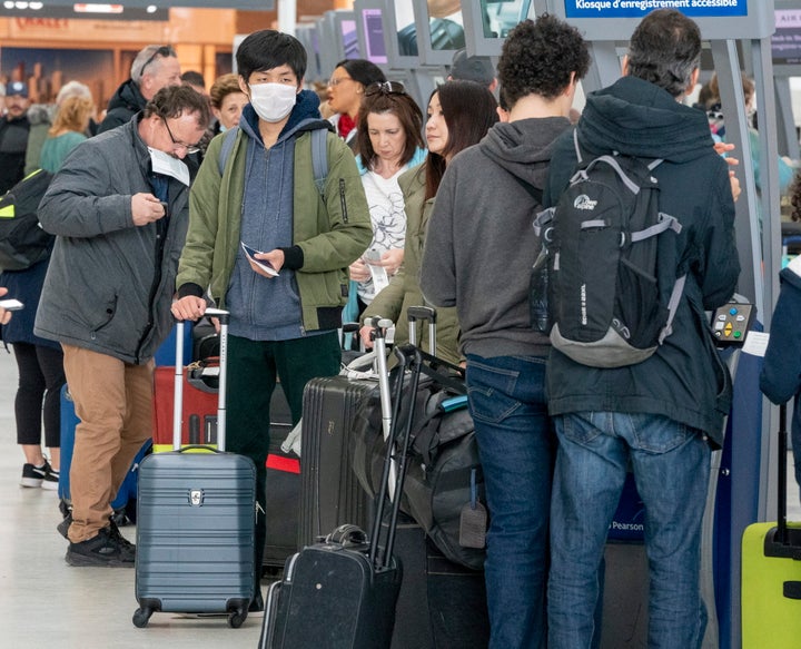 Passengers check in for their flights at Pearson Airport in Toronto on Friday.