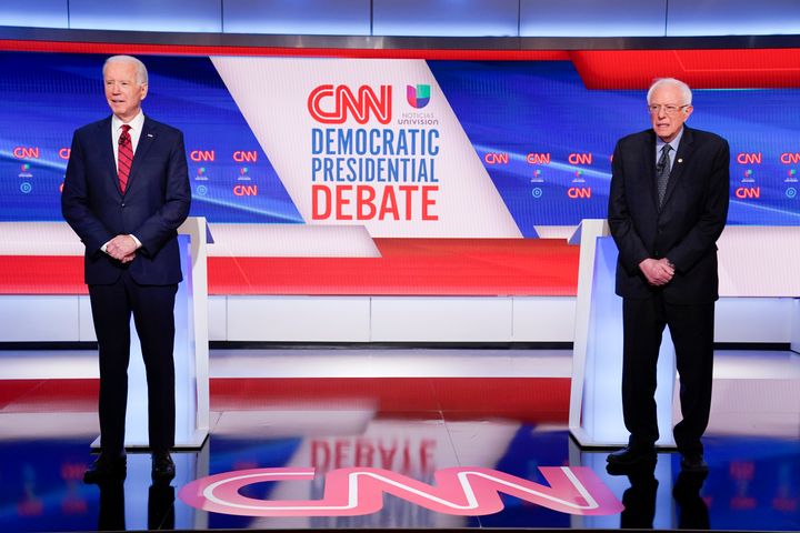 Former Vice President Joe Biden and Sen. Bernie Sanders (I-Vt.) on stage at the Democratic primary debate on Sunday. During the debate, the each laid out what they would do to address the coronavirus outbreak in the U.S.