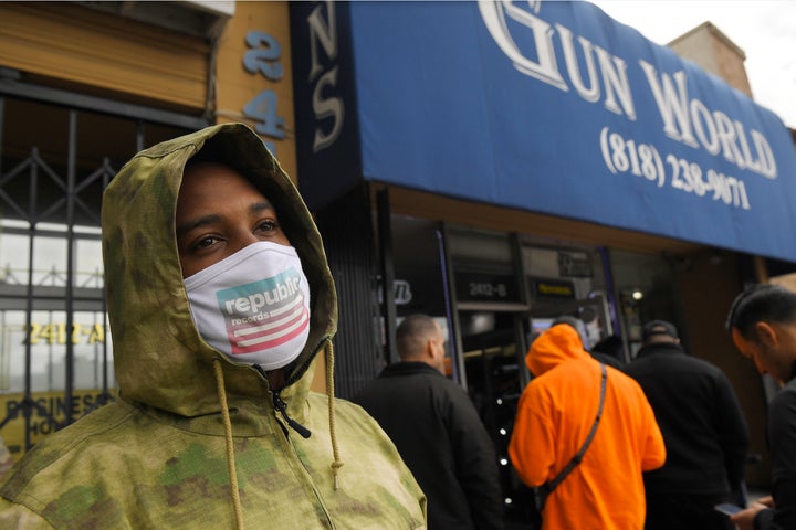 A gun store customer who gave his name only as John waits in line in Burbank, California, on Sunday.