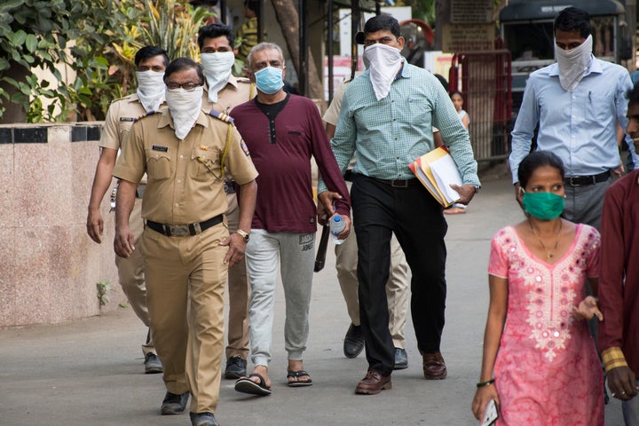 People wear masks as protection from coronavirus at Kasturba Hospital, in Mumbai where Covid-19 suspects and infected patients have been kept