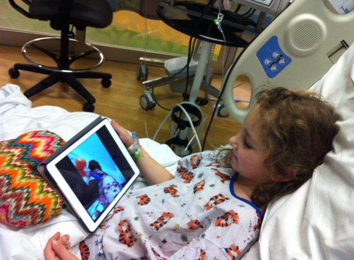 Sammi in the hospital, FaceTiming with her friends.