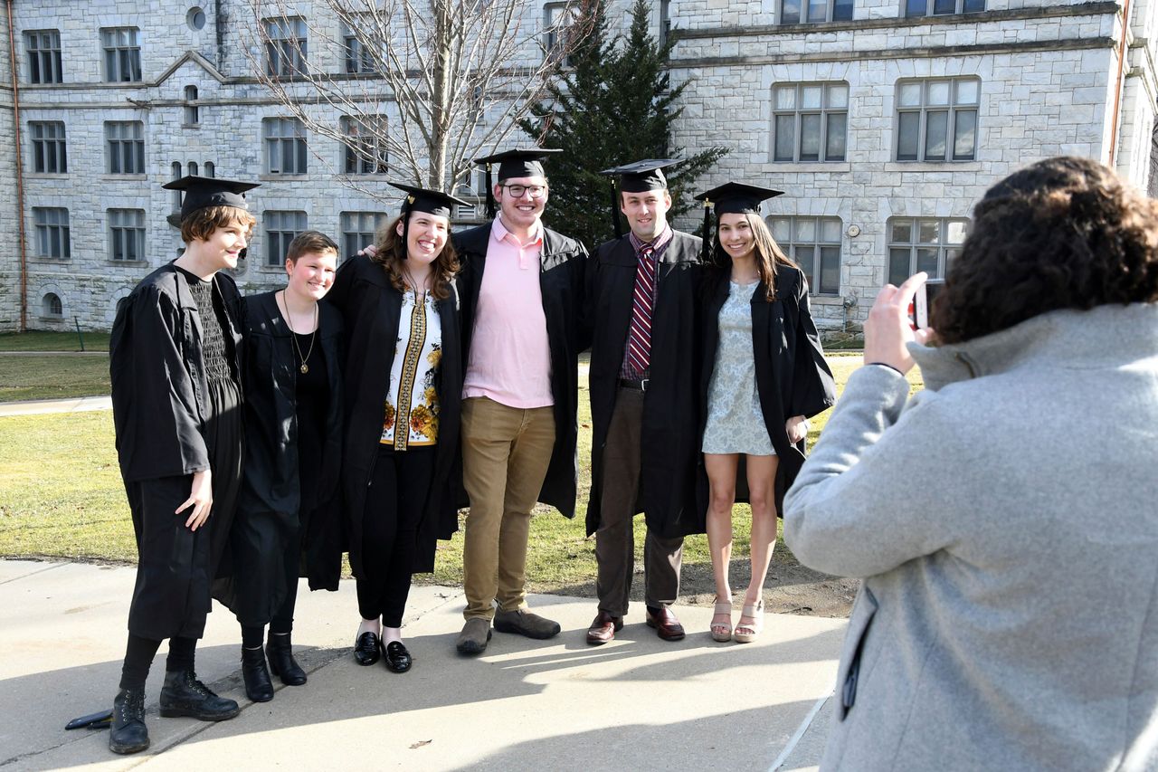 With the end of face-to-face classes and with remote learning to begin on April 6, some Williams College seniors spent last Friday on campus taking photos in their caps and gowns in Williamstown, Massachusetts.