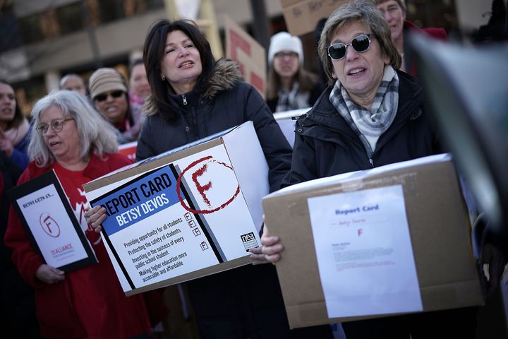 American Federation of Teachers President Randi Weingarten (right) and National Education Association President Lily Eskelsen Garcia (second from right) lead a group to deliver report cards to Secretary of Education Betsy DeVos on Feb. 8, 2018.
