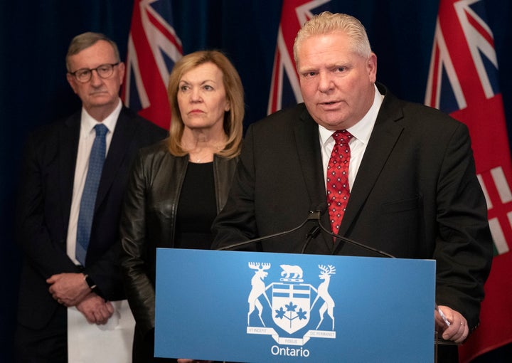 Ontario Premier Doug Ford answers questions as Ontario Health Minister Christine Elliott and Ontario Chief Medical Officer of Health Dr. David Williams, left, listen in during a news conference in Toronto on March 16, 2020.