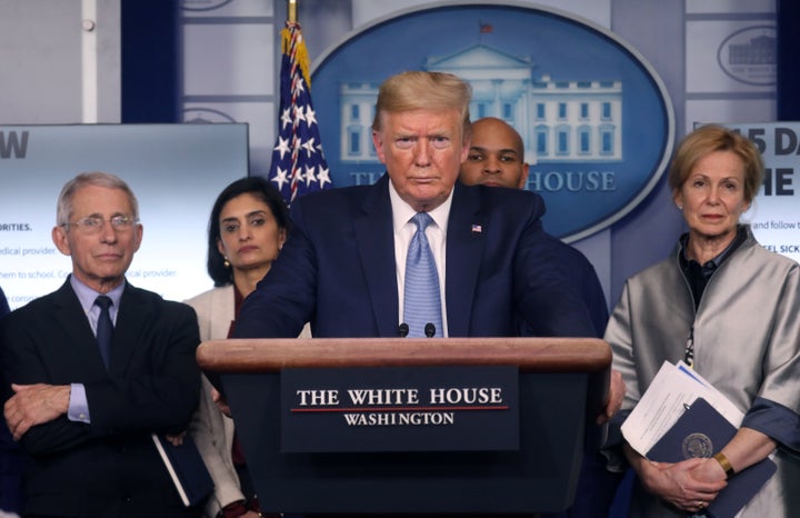 President Donald Trump holds a news briefing Monday on the coronavirus outbreak while accompanied by members of the coronavirus task force at the White House