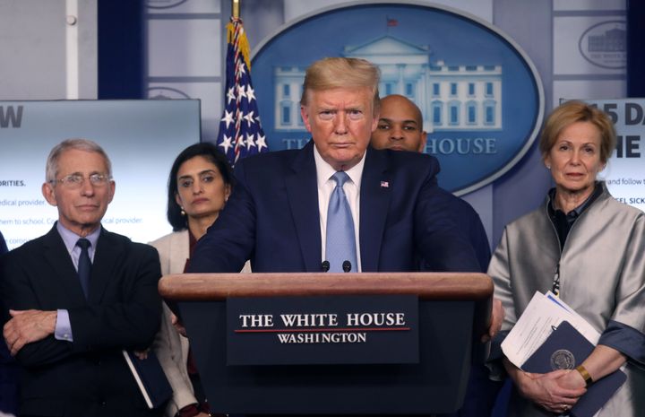 President Donald Trump holds a news briefing Monday on the coronavirus outbreak while accompanied by members of the coronavirus task force at the White House