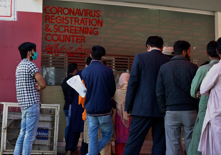People wait their turn at a coronavirus registration and screening counter at the Pakistan Institute of Medical Sciences Hospital, in Islamabad, Pakistan, March 17, 2020. 