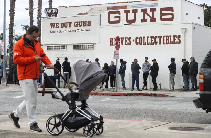 People stand in line outside the Martin B. Retting, Inc. guns store in Culver City, California, on Sunday.