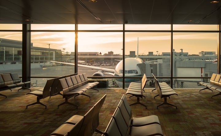 In this stock photo, an airplane can be seen through the window of an empty airport terminal lounge. The world’s major airlines will face bankruptcy within a few months if governments don’t step up immediately with aid, industry groups are warning.