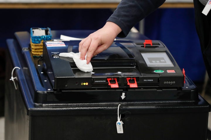 An election official cleaned a voting machine in Chicago as Illinois proceeded with its presidential primary on Tuesday.