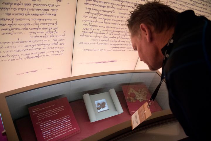 A visitor looks at an exhibit on the Dead Sea scrolls at the Museum of the Bible in Washington, D.C., in 2017. An examination of purported scroll fragments revealed them to be bogus.