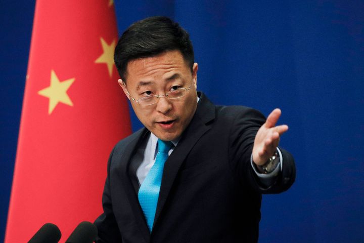 Chinese Foreign Ministry new spokesman Zhao Lijian gestures as he speaks during a daily briefing at the Ministry of Foreign Affairs office in Beijing, Monday, Feb. 24, 2020. (AP Photo/Andy Wong)